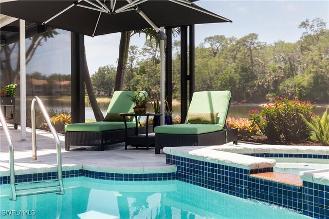 view of pool with a pool with connected hot tub and a patio area