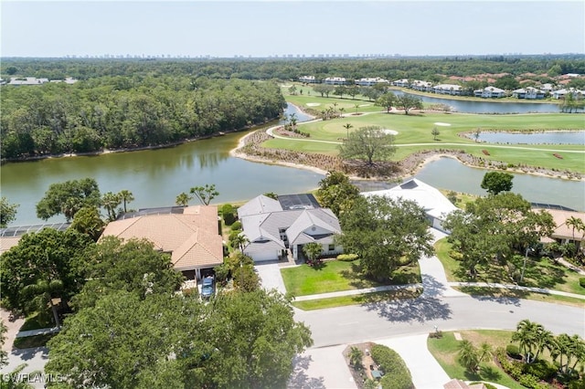 aerial view with view of golf course, a water view, and a residential view