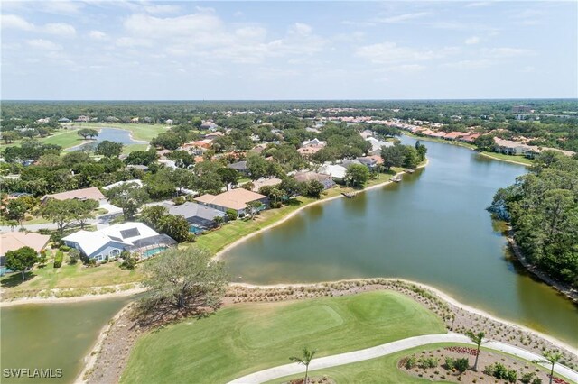birds eye view of property with a residential view, a water view, and view of golf course