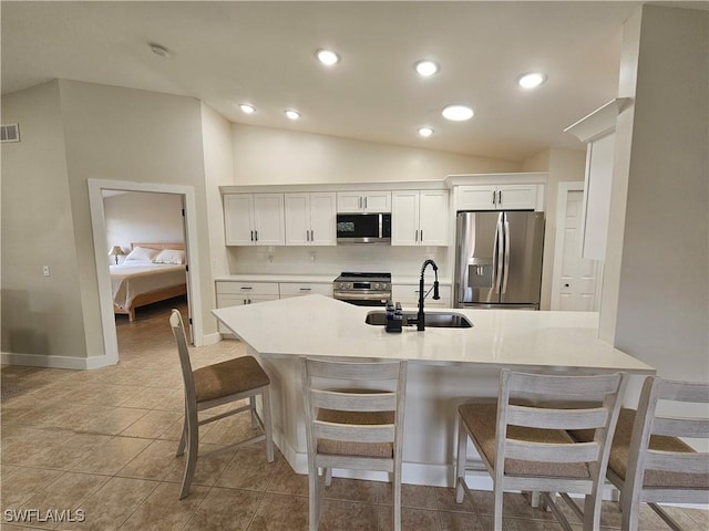 19942 Lake Vista Cir N Unit 2, Lehigh Acres, FL 33936 - kitchen featuring a breakfast bar area, stainless steel appliances, visible vents, and a sink