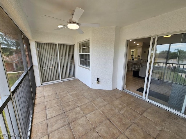 19942 Lake Vista Cir N Unit 2, Lehigh Acres, FL 33936 - unfurnished sunroom featuring ceiling fan