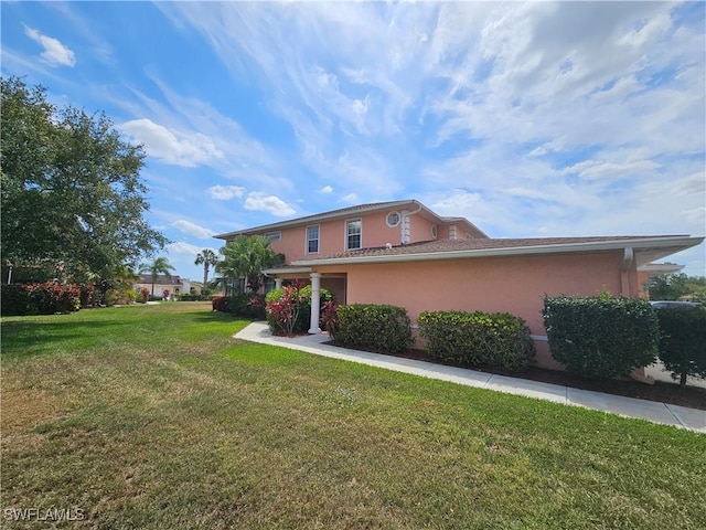19942 Lake Vista Cir N Unit 2, Lehigh Acres, FL 33936 - view of front of home featuring a front lawn and stucco siding
