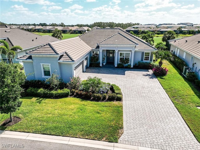 15951 Talon Ter, Punta Gorda, FL 33982 - view of front of home with a tiled roof, an attached garage, driveway, and a residential view