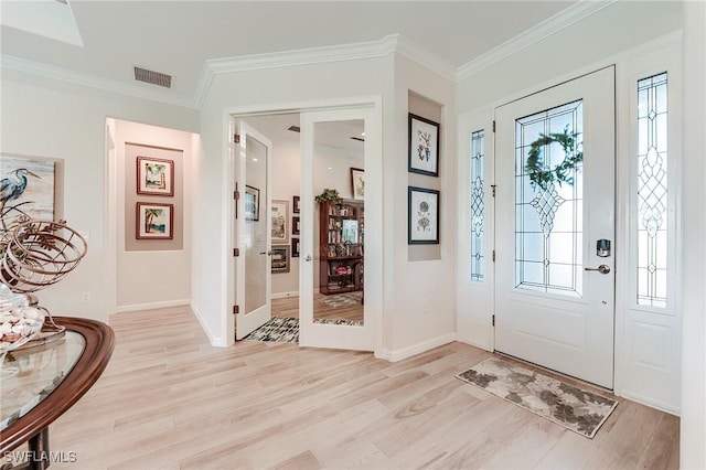 15951 Talon Ter, Punta Gorda, FL 33982 - entrance foyer with light wood-style floors, a healthy amount of sunlight, ornamental molding, and visible vents