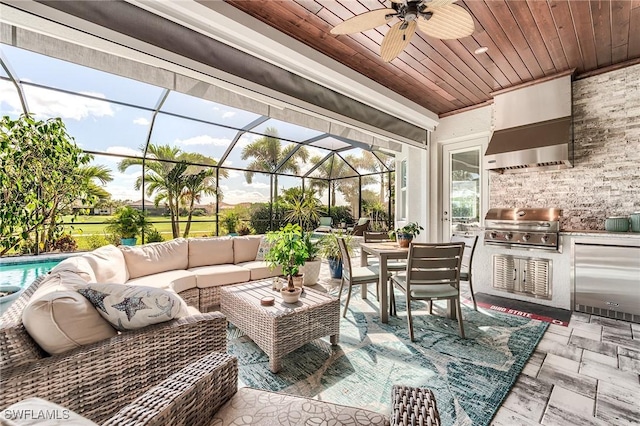 15951 Talon Ter, Punta Gorda, FL 33982 - sunroom / solarium with exterior kitchen, ceiling fan, outdoor lounge area, and outdoor dining area