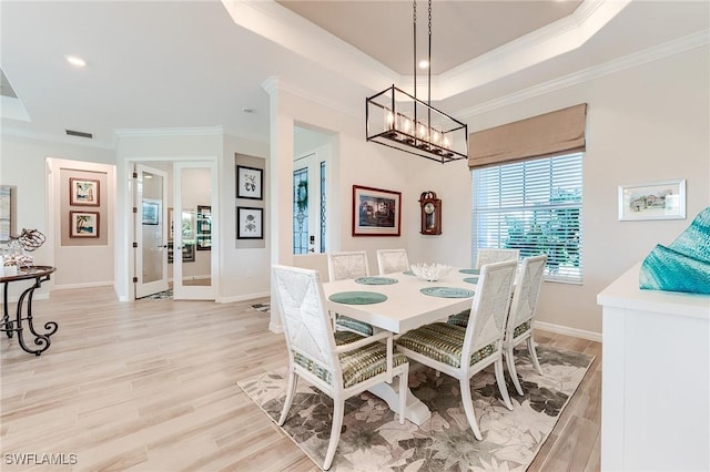 15951 Talon Ter, Punta Gorda, FL 33982 - dining area featuring crown molding, an inviting chandelier, and light wood-type flooring