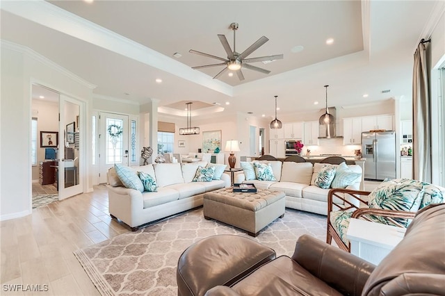 15951 Talon Ter, Punta Gorda, FL 33982 - living area with a ceiling fan, crown molding, a raised ceiling, light wood-style floors, and recessed lighting