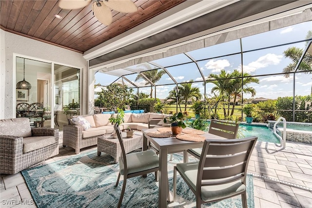15951 Talon Ter, Punta Gorda, FL 33982 - view of patio / terrace featuring glass enclosure, ceiling fan, an outdoor living space, and a pool with connected hot tub