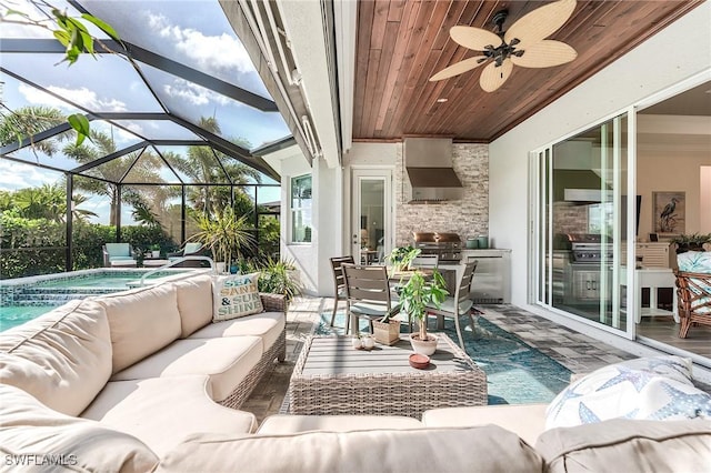 15951 Talon Ter, Punta Gorda, FL 33982 - view of patio with an outdoor kitchen, outdoor lounge area, an in ground hot tub, a ceiling fan, and glass enclosure