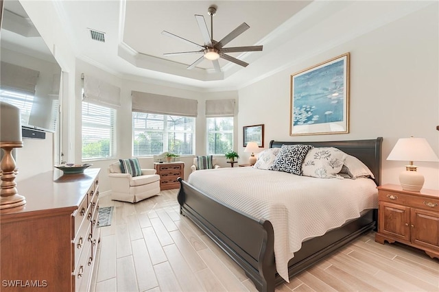 15951 Talon Ter, Punta Gorda, FL 33982 - bedroom with ceiling fan, a raised ceiling, light wood-style flooring, visible vents, and ornamental molding