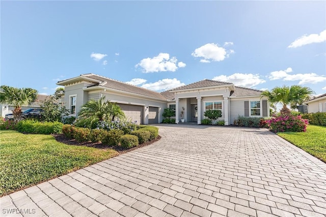 15951 Talon Ter, Punta Gorda, FL 33982 - view of front of home with a garage, stucco siding, a front lawn, and decorative driveway