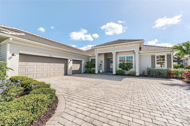 15951 Talon Ter, Punta Gorda, FL 33982 - view of front of property with stucco siding, decorative driveway, a tile roof, and a garage