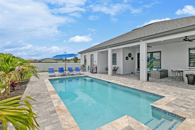 view of pool with a patio, fence, and a ceiling fan