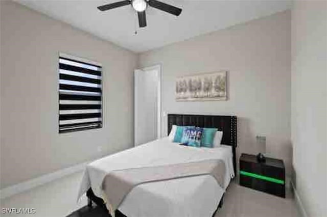 bedroom featuring a ceiling fan and baseboards