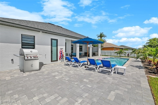 view of swimming pool with a patio, a fenced backyard, and grilling area