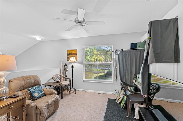 interior space featuring baseboards, vaulted ceiling, ceiling fan, and carpet