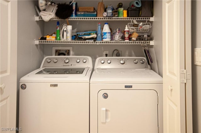 clothes washing area featuring washing machine and clothes dryer and laundry area