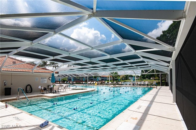 community pool with a lanai and a patio