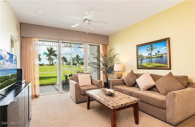carpeted living area featuring a ceiling fan