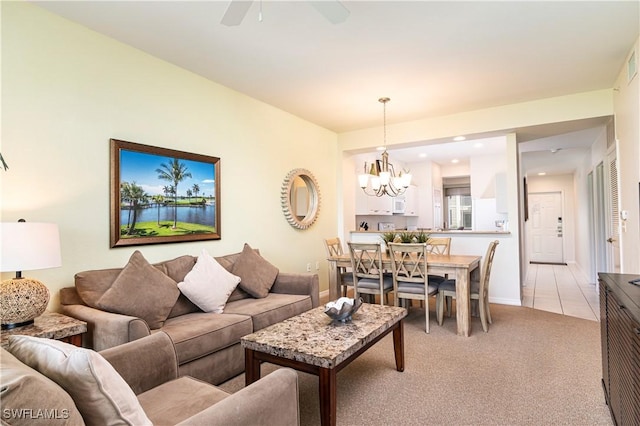 living room with light carpet, a chandelier, a ceiling fan, recessed lighting, and baseboards