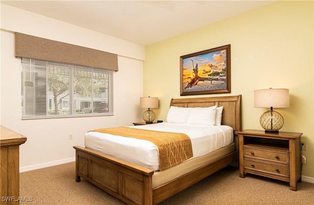 bedroom featuring light colored carpet and baseboards