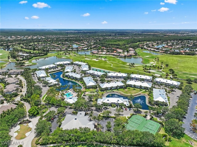view of property location with a nearby body of water, a golf club, and nearby suburban area