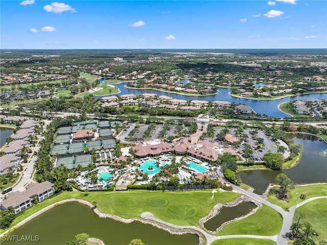 aerial view of property and surrounding area with nearby suburban area, a large body of water, a local golf course, and a pool