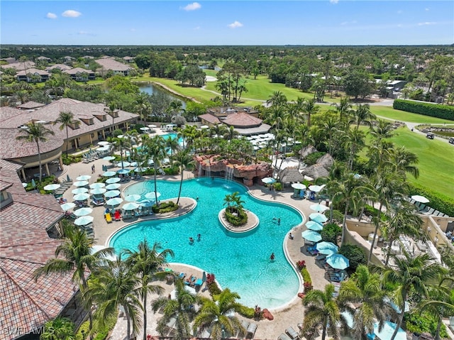 aerial view of residential area with a golf club, a pool, and a tree filled landscape