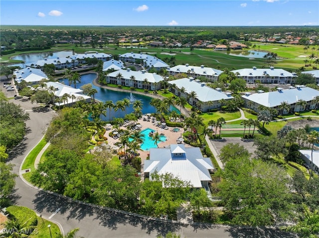 aerial view of residential area featuring a large body of water and a pool area