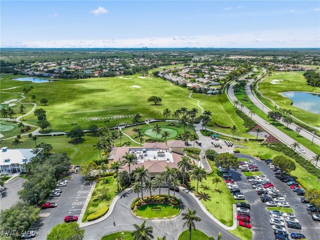 aerial perspective of suburban area with a nearby body of water and a golf club