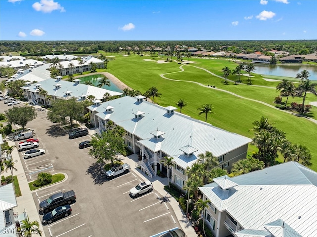 aerial view of residential area with a large body of water and a local golf course
