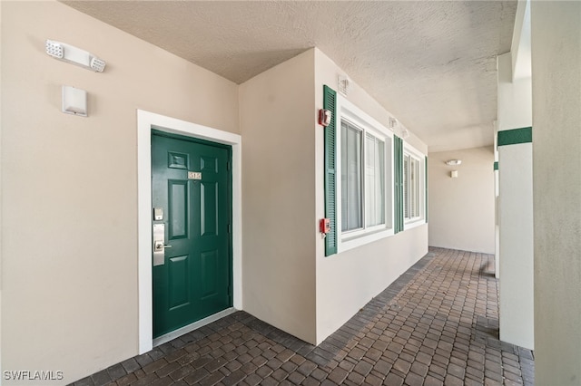 property entrance with stucco siding