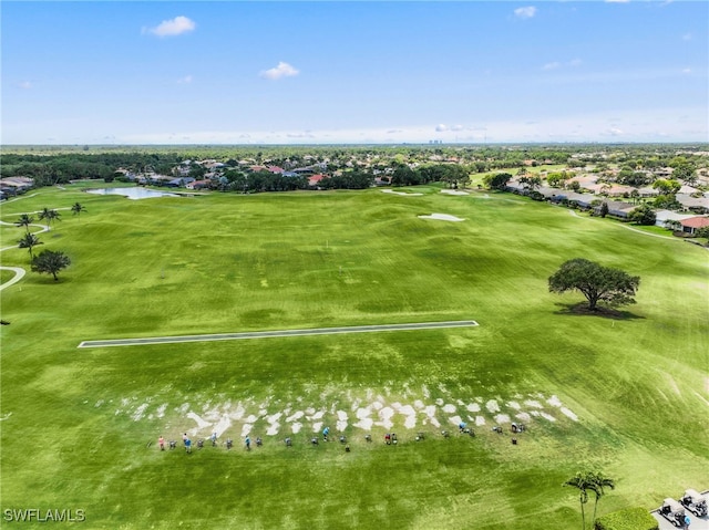 aerial perspective of suburban area with a golf course and a large body of water
