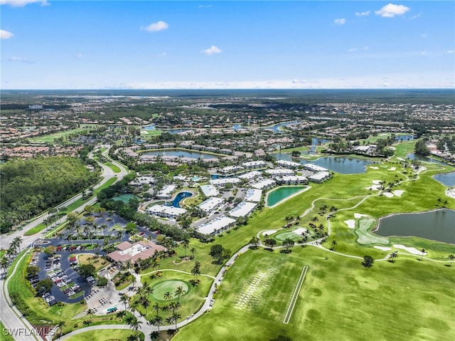 aerial view of property's location featuring a large body of water and a local golf course