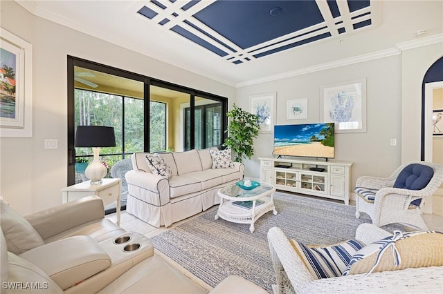 living area with coffered ceiling, crown molding, and arched walkways