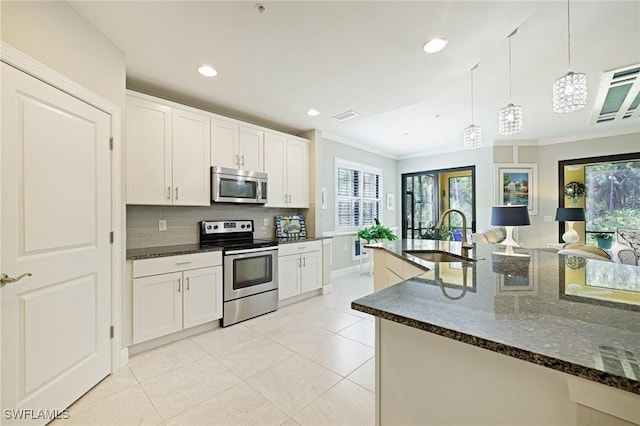 kitchen featuring appliances with stainless steel finishes, a sink, crown molding, backsplash, and light tile patterned floors