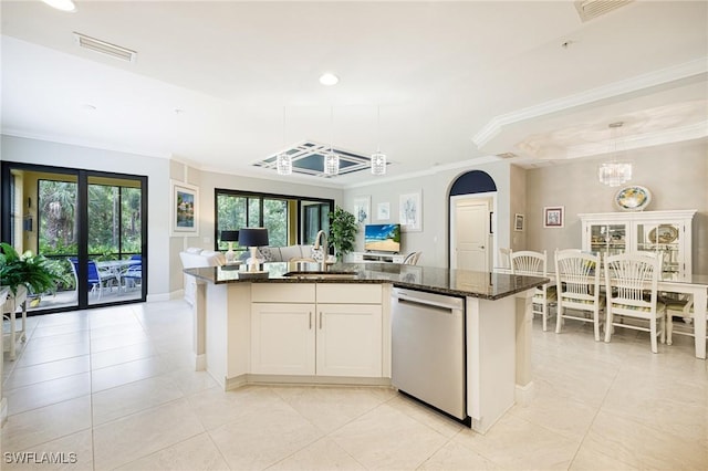 kitchen featuring dishwasher, a sink, open floor plan, a chandelier, and dark stone counters