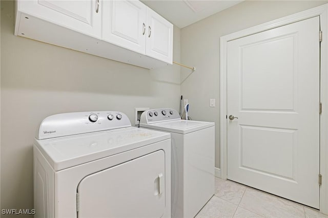 laundry room featuring cabinet space and separate washer and dryer