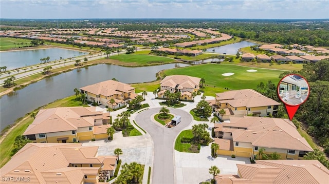 aerial perspective of suburban area featuring a nearby body of water and a golf course