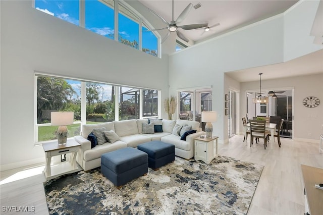 25011 Goldcrest Dr, Bonita Springs, FL 34134 - living area featuring ceiling fan, a wealth of natural light, and a high ceiling