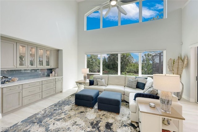 25011 Goldcrest Dr, Bonita Springs, FL 34134 - living room with light wood-style floors, a high ceiling, and ceiling fan