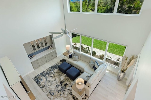 25011 Goldcrest Dr, Bonita Springs, FL 34134 - living room featuring ceiling fan, a high ceiling, light wood finished floors, and a wealth of natural light