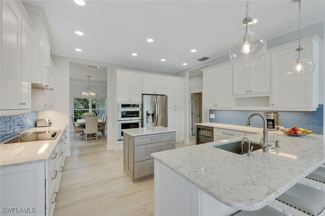 25011 Goldcrest Dr, Bonita Springs, FL 34134 - kitchen with a sink, backsplash, a peninsula, appliances with stainless steel finishes, and recessed lighting