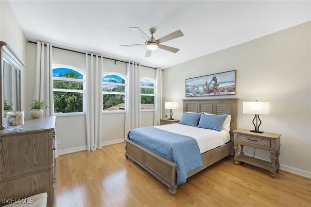 25011 Goldcrest Dr, Bonita Springs, FL 34134 - bedroom with light wood-style floors, baseboards, and ceiling fan