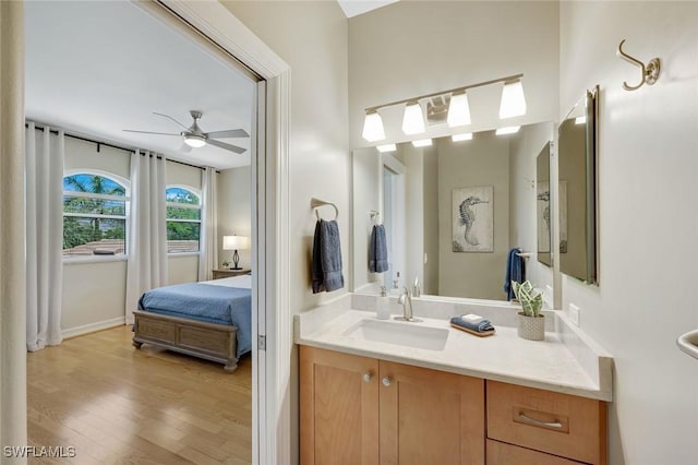 25011 Goldcrest Dr, Bonita Springs, FL 34134 - bathroom featuring ceiling fan, vanity, wood finished floors, and ensuite bathroom