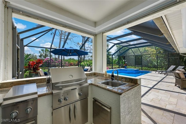 25011 Goldcrest Dr, Bonita Springs, FL 34134 - view of patio / terrace with glass enclosure, an outdoor kitchen, a sink, and an outdoor pool