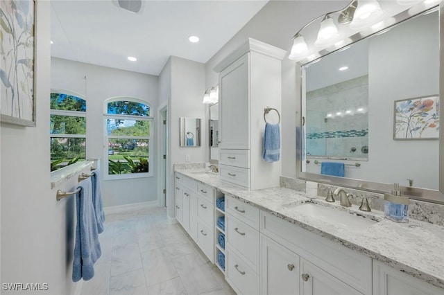 25011 Goldcrest Dr, Bonita Springs, FL 34134 - full bath featuring marble finish floor, a sink, recessed lighting, and tiled shower