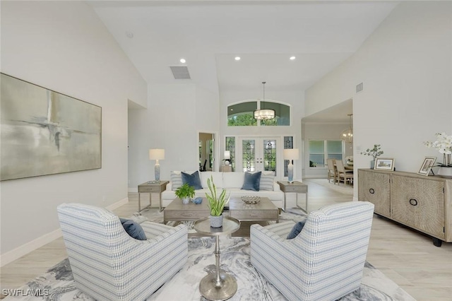 25011 Goldcrest Dr, Bonita Springs, FL 34134 - living area with an inviting chandelier, visible vents, french doors, baseboards, and high vaulted ceiling