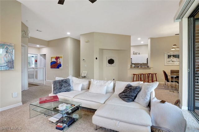 carpeted living room featuring baseboards, recessed lighting, and ceiling fan