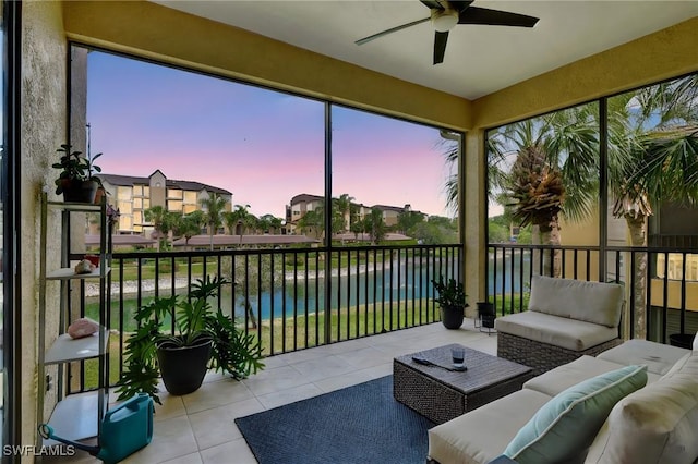 sunroom featuring a water view